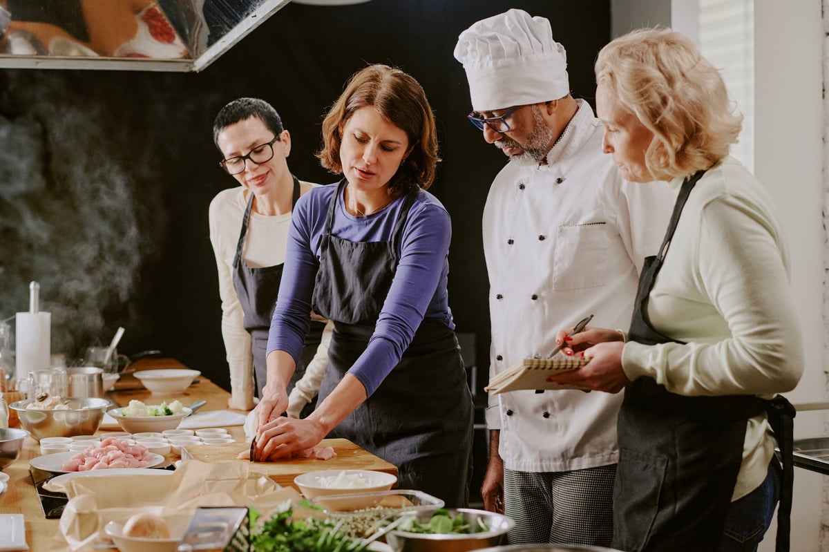 Group of women and chef teaching cooking class